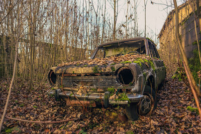 Abandoned car on field