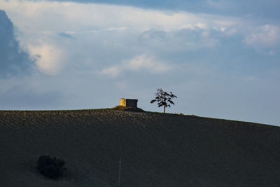 Building on field against sky