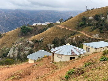 Scenic view of landscape and buildings against sky