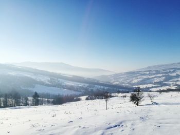 Scenic view of mountains against clear blue sky