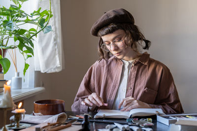 Young woman using mobile phone at home