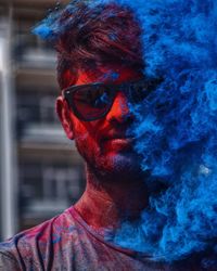 Close-up portrait of man wearing sunglasses