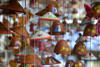 Close-up of multi colored ceramics hanging for sale