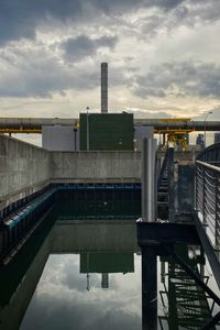 Reflection of buildings in city against sky