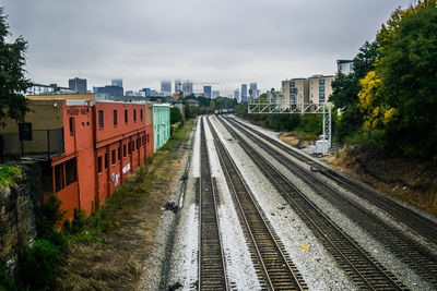 High angle view of railroad tracks amidst buildings in city