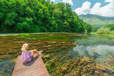 Rear view of woman looking at lake