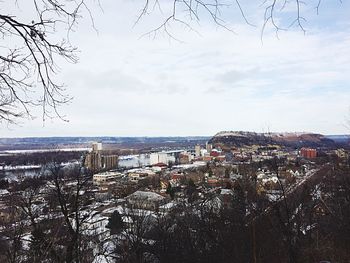 View of cityscape against cloudy sky