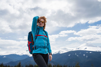 Rear view of woman standing on mountain