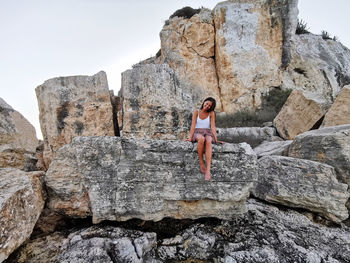 Girl in front of the rock