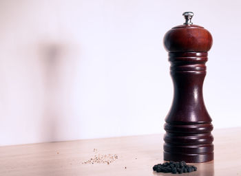 Close-up of wineglass on table against wall