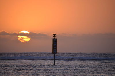 Scenic view of sea against orange sky