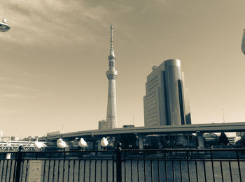 Low angle view of bridge and buildings against sky