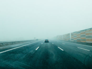 Cars on highway against sky