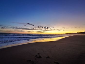 Scenic view of beach against sky during sunset