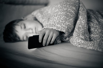 Boy lying on sofa at home