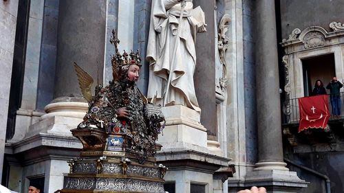 Statue against historic building