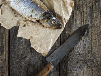 Directly above shot of herring on paper at table