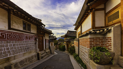 Street amidst buildings against sky