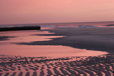 Scenic view of beach against sky during sunset