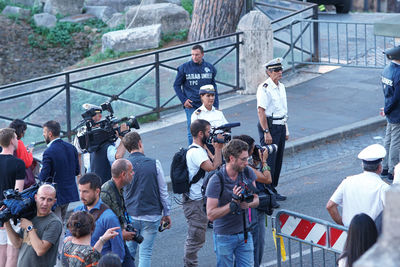 Group of people photographing in city