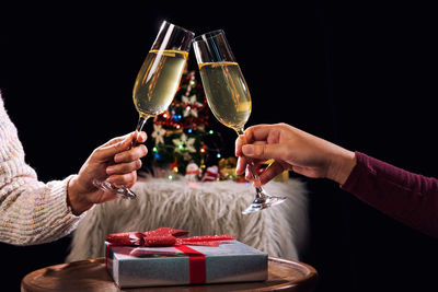 Midsection of friends toasting champagne flutes