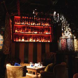 Chairs and table at illuminated restaurant