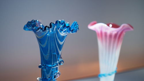 Close-up of glass over blue background