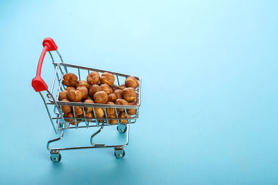 Various fruits in container against blue background