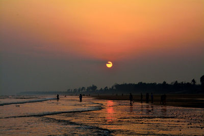 Scenic view of beach against sky during sunset