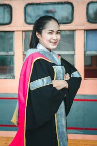 Portrait of a smiling young woman standing outdoors