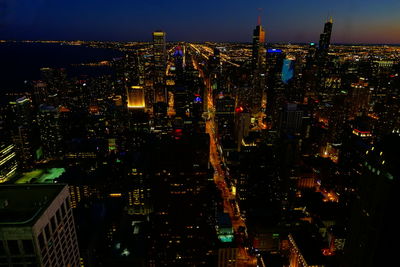 High angle view of illuminated buildings in city at night