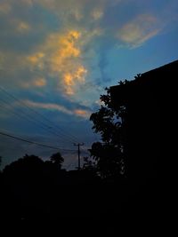 Low angle view of silhouette trees against sky during sunset