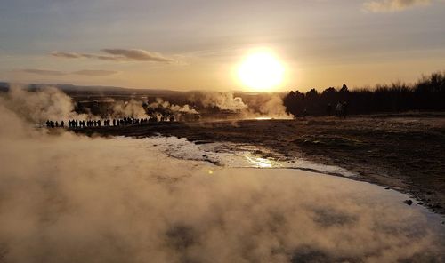 Scenic view of sunset over steaming geysir