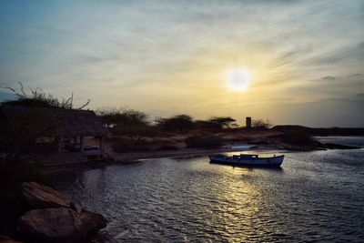 Scenic view of river against sky during sunset