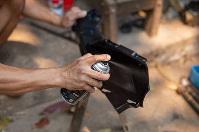 Midsection of man holding camera