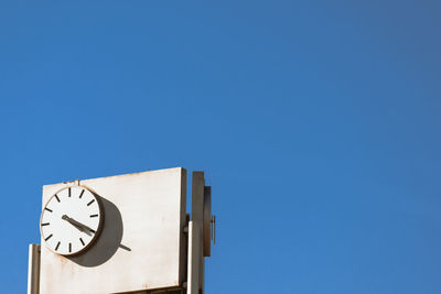 Low angle view of clock tower against clear sky