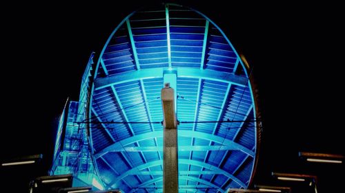 Low angle view of illuminated ferris wheel at night