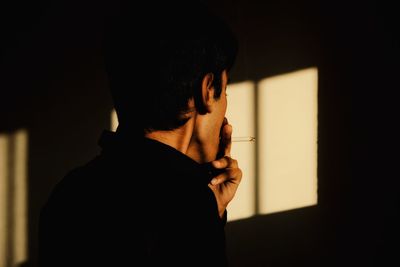 Portrait of young man holding cigarette