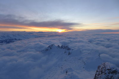 Scenic view of snow mountains against sky during sunset