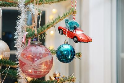 Close-up of christmas decorations hanging on tree