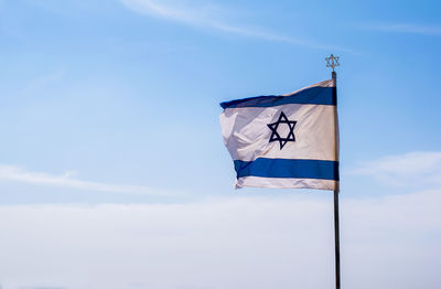 Low angle view of flag against sky