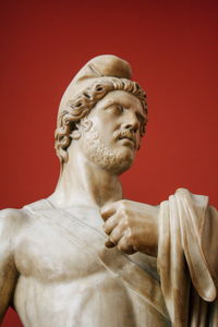 Close-up of statue against red background