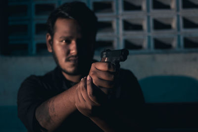 Portrait of young man holding smart phone