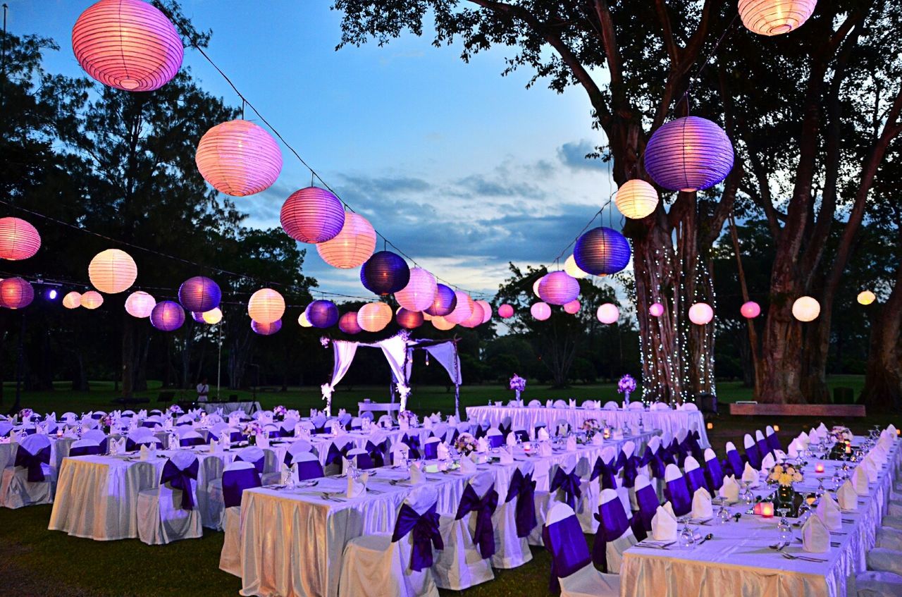 hanging, decoration, multi colored, in a row, low angle view, variation, celebration, large group of objects, tradition, flower, lantern, cultures, abundance, sky, lighting equipment, colorful, arrangement, no people, outdoors, traditional festival