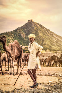 Full length of man standing on land against sky