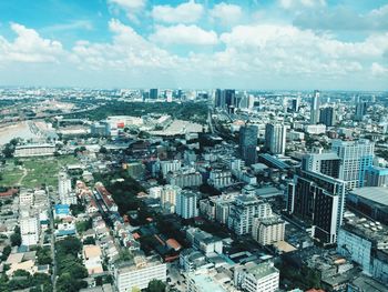 High angle view of modern buildings in city against sky