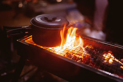Close-up of lit candles on barbecue grill
