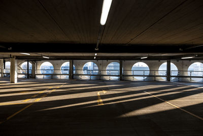 Uk, england, manchester, arches casting shadows in empty multi storey parking lot