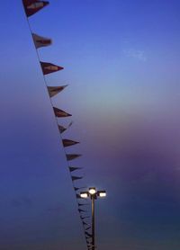 Low angle view of row against blue sky