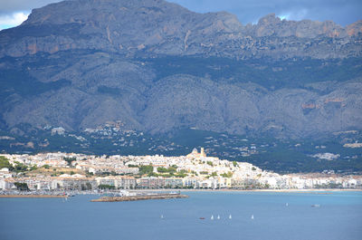 Scenic view of sea and mountains against sky